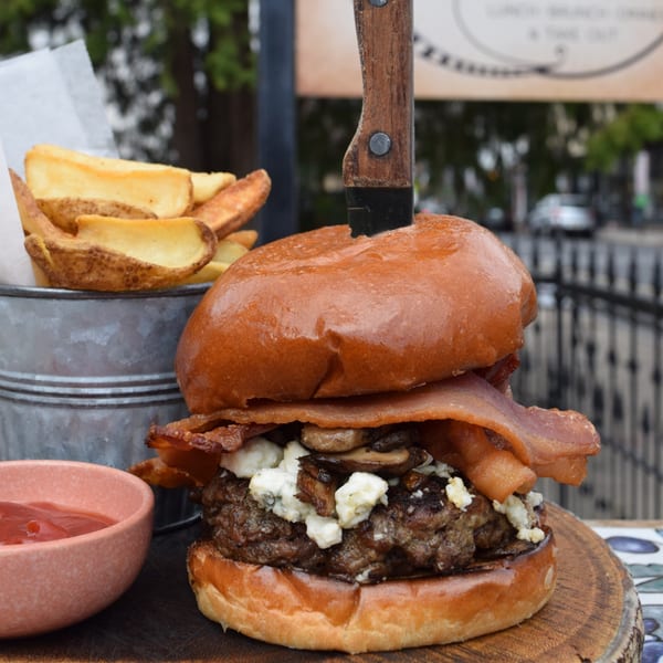 Under the Moon's bacon, mushroom, and blue cheese burger with steak fries and ketchup.